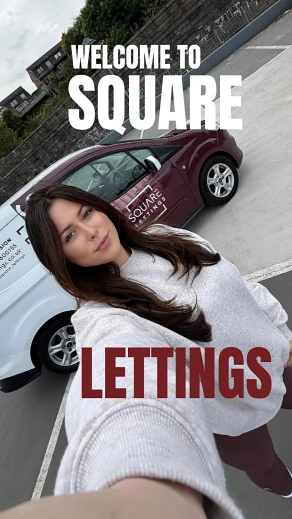 Emma taking a selfie in front of the maroon Square Lettings car